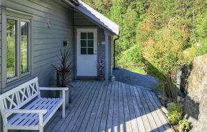 a house with a bench on a wooden porch at Stunning Home In Hebnes With Kitchen in Hebnes