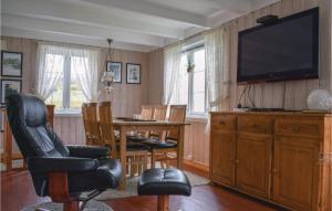 Valevågにある3 Bedroom Amazing Home In Valevgのリビングルーム(テレビ、テーブル、椅子付)