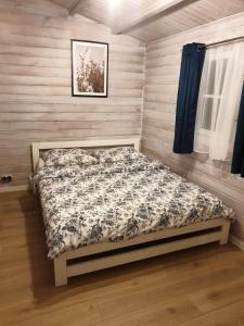 ビエレにあるWielewski Cypel Domki letniskowe na Kaszubach Wieleの木製の壁のベッドルーム1室(ベッド1台付)