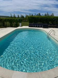 a large swimming pool with blue water at Green Oasis in Stolniceni-Prăjescu