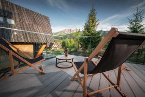 twee stoelen en een tafel op een terras met uitzicht bij VIP Chalet ZAKOPANE in Kościelisko