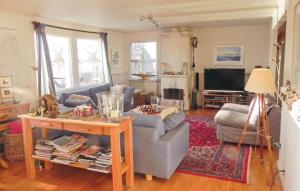 a living room with a couch and a table at 3 Bedroom Lovely Home In Vaxholm in Vaxholm