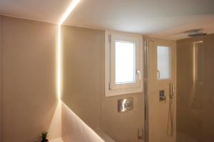 a bathroom with a shower and a window at Spiliada Private House Batsi in Batsi