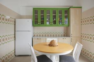 a kitchen with a wooden table and a refrigerator at Spiliada Private House Batsi in Batsi