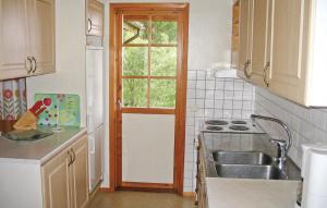 a kitchen with a sink and a window at Nice Home In Gislaved With Sauna in Våthult