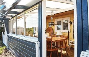 a screened in porch with a table and a dining room at Gorgeous Home In Hörby With Kitchen in Hörby