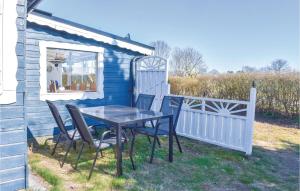 a table and chairs in front of a blue house at Gorgeous Home In Hörby With Kitchen in Hörby