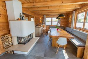 a living room with a fireplace in a tiny house at Chalet Huber by Alpenidyll Apartments in Aich