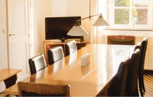 a conference room with a large wooden table and chairs at Seven-Bedroom Holiday Home In Remersdaal in Remersdaal