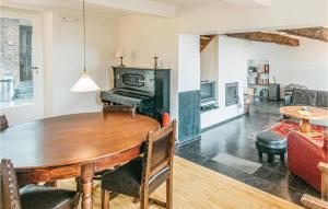a dining room with a table and a living room at Seven-Bedroom Holiday Home In Remersdaal in Remersdaal