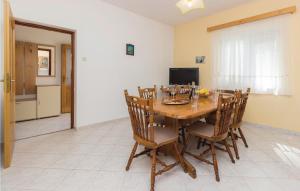 a dining room with a wooden table and chairs at 6 Bedroom Beautiful Home In Kraj in Kraj