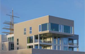 a building with glass windows on the side of it at Priwallpromenade 1, Whg 3 in Travemünde
