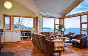 a living room with a view of the water at Nice Home In Nedstrand With Sauna in Nedstrand
