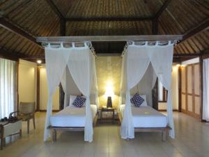 Postel nebo postele na pokoji v ubytování Bumi Ubud Resort + 37 fotografií