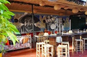 a restaurant with a bar with a mural of a cowboy at El Kennaria in Marrakesh