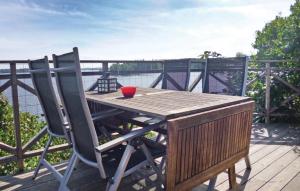 a wooden table and two chairs on a deck at Pet Friendly Home In Tranås With Sauna in Tranås +38 photos