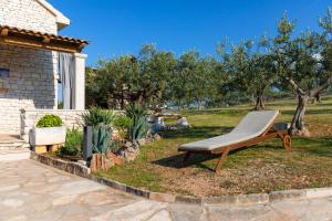 a bench in a yard next to a house at House Marina in Postira