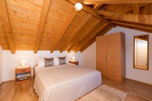 a bedroom with a white bed and wooden ceilings at House Marina in Postira +45 photos