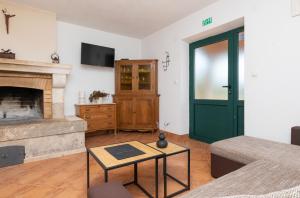 a living room with a fireplace and a green door at House Marina in Postira