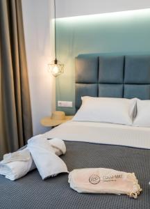 a bedroom with a bed with towels on the floor at Azzurro Deluxe in Limenaria