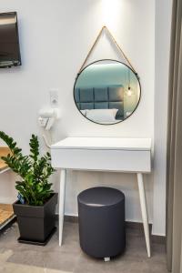 a bathroom with a white sink and a mirror at Azzurro Deluxe in Limenaria