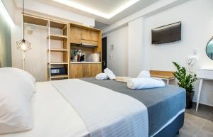 a bedroom with a large bed and a tv at Azzurro Deluxe in Limenaria