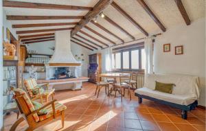 a living room with a table and chairs and a fireplace at Villa I Cedri in Santa Lucia