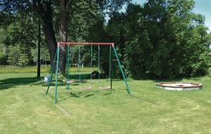an empty swing set in a grassy field at Stunning Home In Vrigstad With Wifi in Vrigstad