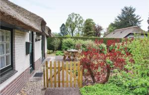 een tuin met een houten hek voor een huis bij 2 Bedroom Beautiful Home In Ermelo in Ermelo