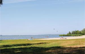 a group of people laying on the beach near the water at 2 Bedroom Beautiful Home In Ermelo in Ermelo