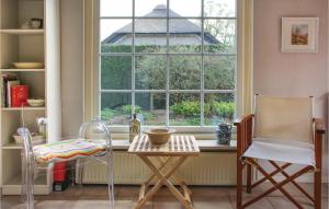 a kitchen with a table and two chairs and a window at 2 Bedroom Beautiful Home In Ermelo in Ermelo +12 photos
