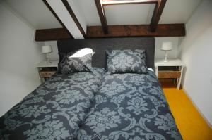 a bedroom with a bed and two night stands at Bed & Breakfast de Kreitsberg in Duifhuis
