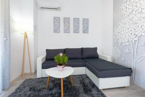 a living room with a couch and a table at Apartment Kosic n1 beautiful & cosy in Krk