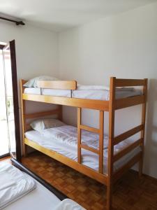 a couple of bunk beds in a room at Sobe Apartma Galic in Novi Vinodolski