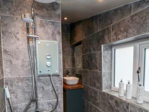 a bathroom with a shower and a sink at Stonewall in Whitby +14 photos