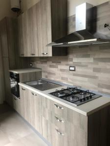 a kitchen with a stove top oven in a kitchen at FORIA 58 APARTAMENTS in Naples