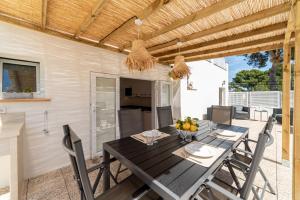 a dining room with a table and chairs on a patio at Apartamento Paraiso de Son Moll in Cala Ratjada
