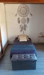 a bedroom with a bed with a painting on the wall at Camping des Tourbières - Gîtes in Vendoire