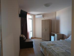 A bed or beds in a room at Aura Family Hotel