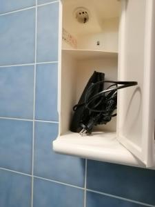 a cupboard with a bunch of wires in it at Sobe Apartma Galic in Novi Vinodolski