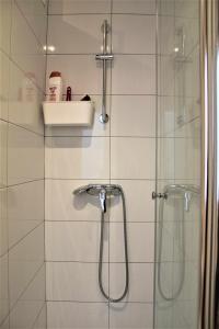 baño con ducha y puerta de cristal en Acogedor apartamento en el Rabal en Zaragoza