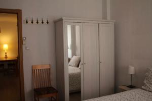 a bedroom with a white cabinet and a bed at Acogedor apartamento en el Rabal in Zaragoza