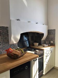 a kitchen with a bowl of vegetables on a counter at Villa Miranda in Halki +26 photos