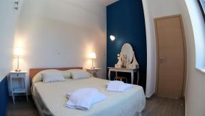 a bedroom with a bed with two towels on it at Villa Miranda in Halki