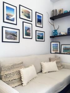 a white couch in a living room with pictures on the wall at Villa Miranda in Halki