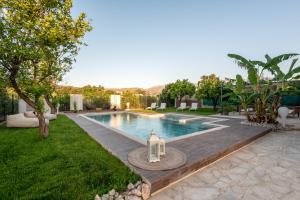 a swimming pool in the middle of a yard at Elenas Village house - Dream apt w Pool & Terrace in Alikianós