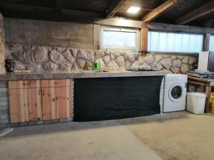 a kitchen with a stove and a microwave at Sobe Apartma Galic in Novi Vinodolski