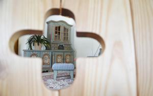 a mirror reflection of a room with a chair at Hotel Aquamarin in Bad Mitterndorf