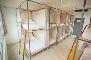 a group of four bunk beds in a room at Corner Hostel & Cafe in Taipei