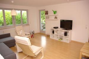 a living room with a couch and a tv at Leipzig City Appartments in Leipzig